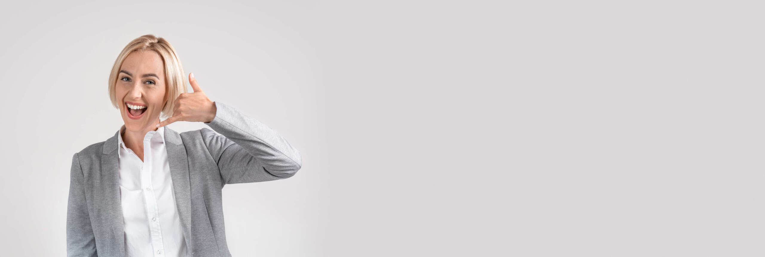 Contact Us. Wide Horizontal Banner With Smiling Businesswoman Showing Phone Call Gesture